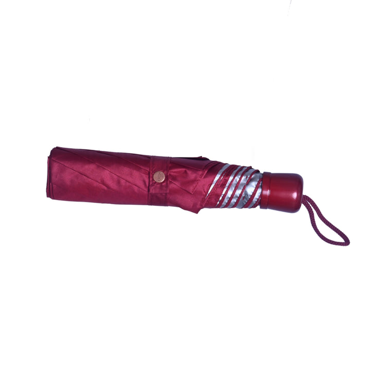 Foldable umbrella with a red handle and silver stripes on a white background